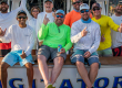 team agitator laughing at back of their fishing boat