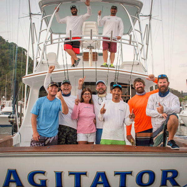 Agitator Winners entire team of agitaor on back of boat laughing